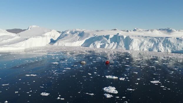 Aerial view of Ilulissat glacier and icebergs in Greenland.