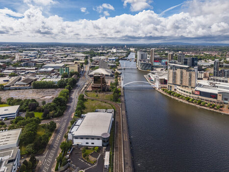 Aerial view of the Manchester Ship Canal and MediaCityUK with modern buildings the Lowry Bridge and surrounding urban infrastructure in Stretford England United Kingdom.