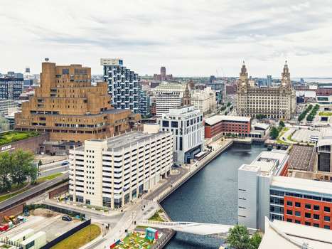 Aerial view of the historic waterfront featuring the Royal Liver Building modern architecture and the canal basin in Liverpool England United Kingdom.