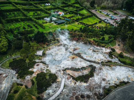Aerial view of steaming earth and bubbling pools create an otherworldly landscape contrasting with the geometric gardens and verdant fields Furnas Azores Portugal. Aerial view of steaming earth and bubbling pools create an otherworldly landscape contrasting with the geometric gardens and verdant fields Furnas Azores Portugal.