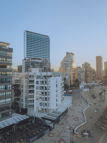 Aerial view of modern high rise apartment buildings along the sandy beach and promenade in Calp Valencian Community Spain. Aerial view of modern high rise apartment buildings along the sandy beach and promenade in Calp Valencian Community Spain.