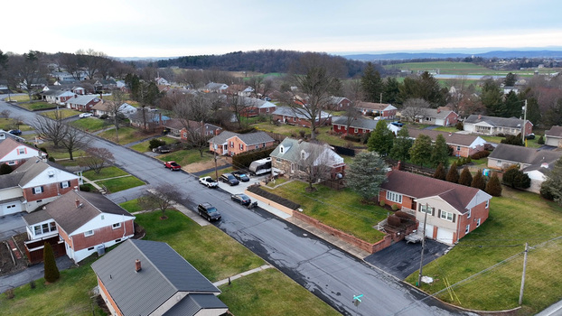 Aerial view of a residential neighborhood with suburban houses paved streets and bare winter trees in Akron Pennsylvania United States.