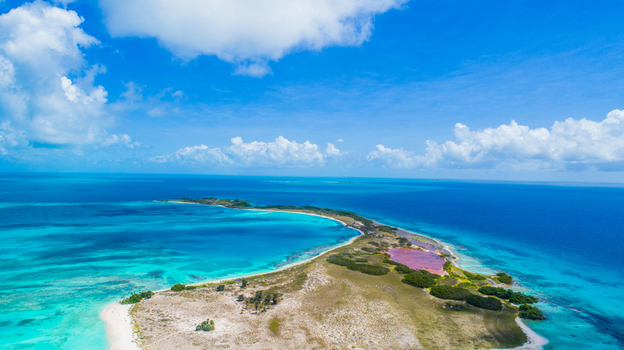 Aerial view of Los Roques archipelago with turquoise Caribbean waters white sandy beaches and a pink salt flat Los Roques Dependencias Federale Venezuela. Aerial view of Los Roques archipelago with turquoise Caribbean waters white sandy beaches and a pink salt flat Los Roques Dependencias Federale Venezuela.