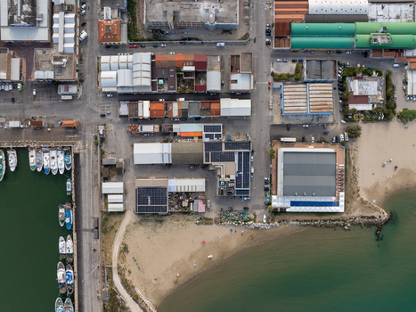 Aerial view of the port authorities area featuring docked fishing boats industrial buildings with solar panels and a sandy beach in San Benedetto del Tronto Marche Italy. Aerial view of the port authorities area featuring docked fishing boats industrial buildings with solar panels and a sandy beach in San Benedetto del Tronto Marche Italy.