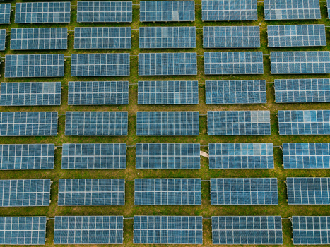 Aerial view of rows of solar panels in a solar farm capturing the grid like pattern of the photovoltaic modules set against the grassy landscape in Ogun State Nigeria.