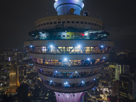 Kuala Lumpur Malaysia 11 March 2026 Aerial view of the illuminated observation deck of the Kuala Lumpur Tower at night with the city skyline in the background.