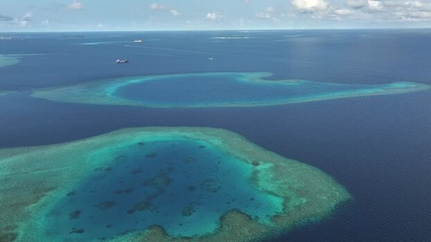 Aerial view of turquoise coral reefs and deep blue ocean waters Maldives. Aerial view of turquoise coral reefs and deep blue ocean waters Maldives.