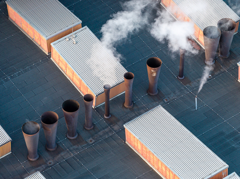 Aerial view of the Heizkraftwerk Klingenberg combined heat and power plant with industrial chimneys emitting steam and corrugated metal roofs in Berlin Berlin Germany. Aerial view of the Heizkraftwerk Klingenberg combined heat and power plant with industrial chimneys emitting steam and corrugated metal roofs in Berlin Berlin Germany.