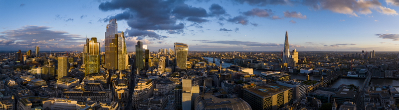 Aerial view of the Thames river snaking through the city reflecting the fading light with The Shard piercing the skyline London England United Kingdom. Aerial view of the Thames river snaking through the city reflecting the fading light with The Shard piercing the skyline London England United Kingdom.