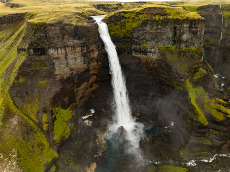 Aerial view of Haifoss waterfall cascading into a deep canyon with mossy cliffs and rugged volcanic rock formations in Skeida og Gnupverjahreppur Iceland. Aerial view of Haifoss waterfall cascading into a deep canyon with mossy cliffs and rugged volcanic rock formations in Skeida og Gnupverjahreppur Iceland.
