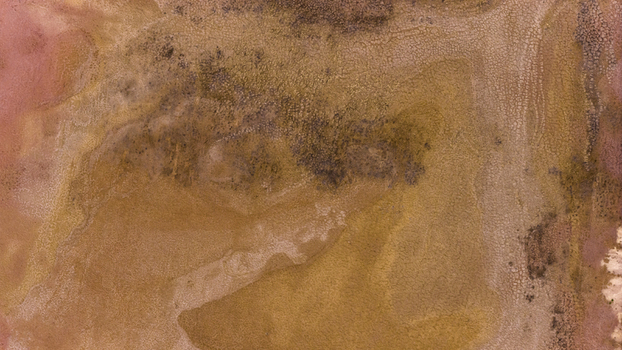 Aerial view of abstract salt lake patterns with brown and yellow sand deposits and textured salt crust in Kalbarri Western Australia Australia. Aerial view of abstract salt lake patterns with brown and yellow sand deposits and textured salt crust in Kalbarri Western Australia Australia.