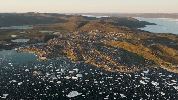 Aerial view of Ilulissat town and icebergs in Greenland. Aerial view of Ilulissat town and icebergs in Greenland.