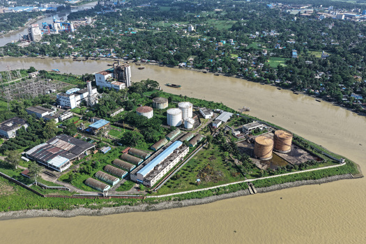Aerial view of the industrial facility along the Karnaphuli River with storage tanks and surrounding greenery in Chattogram Chattogram Division Bangladesh.