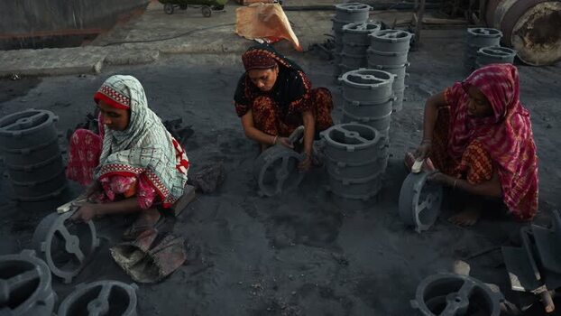 View of women cleaning metal castings in Bogura Bangladesh.