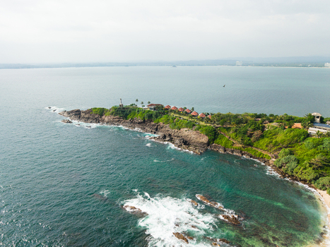 Aerial view of Secret Beach Mirissa with its rocky coastline and turquoise waters surrounded by lush tropical trees in Mirissa Southern Province Sri Lanka. Aerial view of Secret Beach Mirissa with its rocky coastline and turquoise waters surrounded by lush tropical trees in Mirissa Southern Province Sri Lanka.