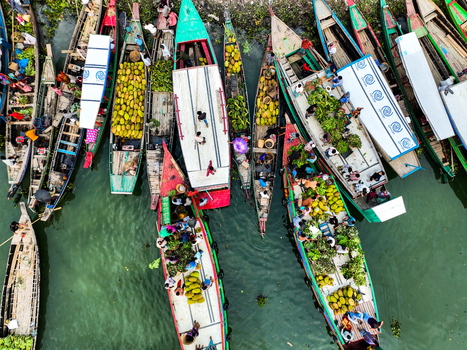 Rangamati Hill District Chittagong Division Bangladesh 18 May 2024 Aerial view of Kaptai Lake with wooden boats loaded with jackfruit and people navigating the water.