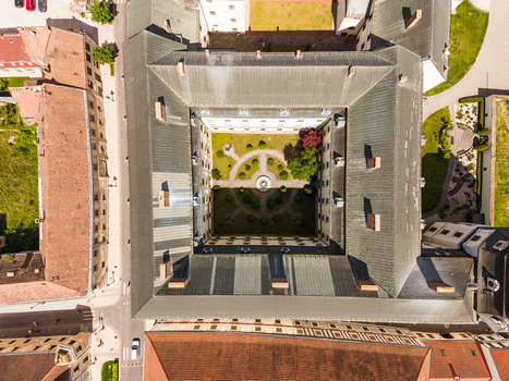 Aerial view of the historic university building with its symmetrical inner courtyard and manicured garden in Trnava Trnava Region Slovakia. Aerial view of the historic university building with its symmetrical inner courtyard and manicured garden in Trnava Trnava Region Slovakia.