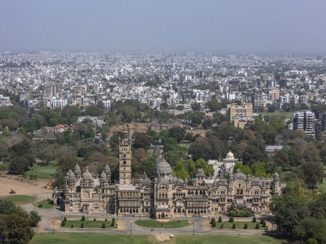 Vadodara India 14 March 2026 Aerial view of Laxmi Vilas Palace featuring its ornate Indo Saracenic architecture tall tower and domes surrounded by lush gardens with the city skyline. Vadodara India 14 March 2026 Aerial view of Laxmi Vilas Palace featuring its ornate Indo Saracenic architecture tall tower and domes surrounded by lush gardens with the city skyline.
