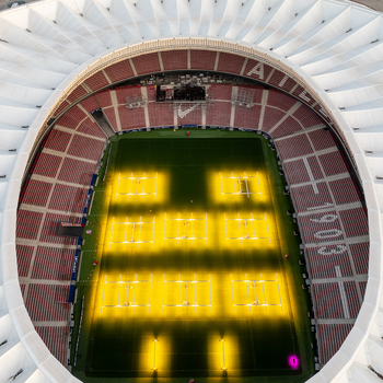 Aerial view of Riyadh Air Metropolitano Stadium with bright artificial turf lighting illuminating the pitch in Madrid Comunidad de Madrid Spain.