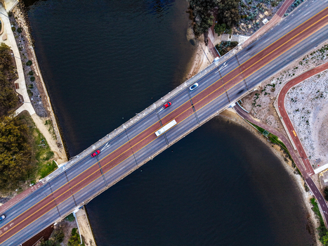 Aerial view of Boorloo Bridge with vehicles crossing the river surrounded by paths and vegetation in East Perth Western Australia Australia.