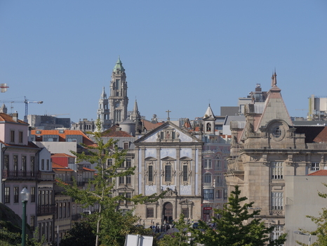 View of the historic Igreja dos Congregados with its blue tiled facade surrounded by traditional urban architecture and the clock tower of the Porto City Hall in Porto Porto District Portugal. View of the historic Igreja dos Congregados with its blue tiled facade surrounded by traditional urban architecture and the clock tower of the Porto City Hall in Porto Porto District Portugal.