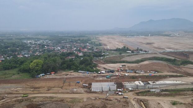 Aerial view of Dhoho International Airport construction site featuring concrete structures heavy machinery and surrounding rural landscape in Kecamatan Grogol Jawa Timur Indonesia. Aerial view of Dhoho International Airport construction site featuring concrete structures heavy machinery and surrounding rural landscape in Kecamatan Grogol Jawa Timur Indonesia.