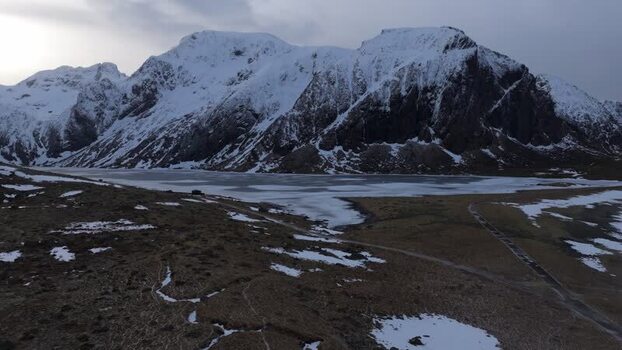 Aerial view of Lofoten mountains and frozen lake Norway.