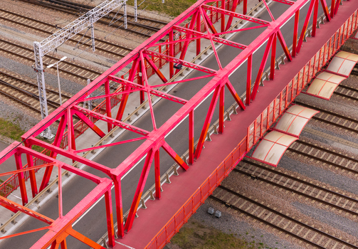 Aerial view of the Historic Red Steel Truss Viaduct spanning over railway tracks in Gdansk Pomeranian Voivodeship Poland. Aerial view of the Historic Red Steel Truss Viaduct spanning over railway tracks in Gdansk Pomeranian Voivodeship Poland.
