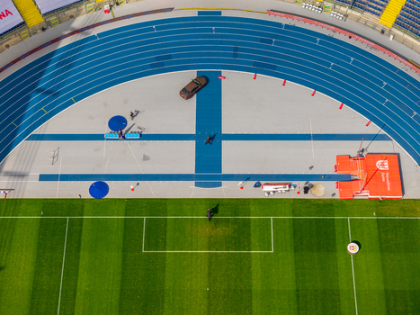 Chorzow Poland 17 September 2026 Aerial view of Silesian Stadium featuring a blue running track and green grass pitch with athletic equipment visible.