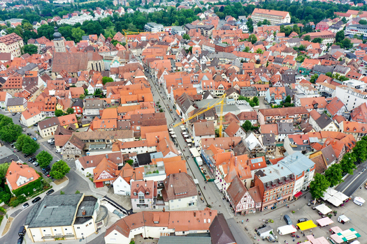 Aerial view of the historic old town with red tiled roofs St. Martin s Church and a bustling market square in Forchheim Bavaria Germany. Aerial view of the historic old town with red tiled roofs St. Martin s Church and a bustling market square in Forchheim Bavaria Germany.