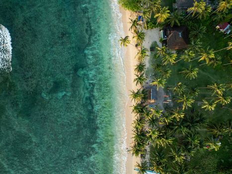Aerial view of Mahaybo Beach with turquoise water white sand and lush palm trees along the coastline in General Luna Caraga Philippines. Aerial view of Mahaybo Beach with turquoise water white sand and lush palm trees along the coastline in General Luna Caraga Philippines.