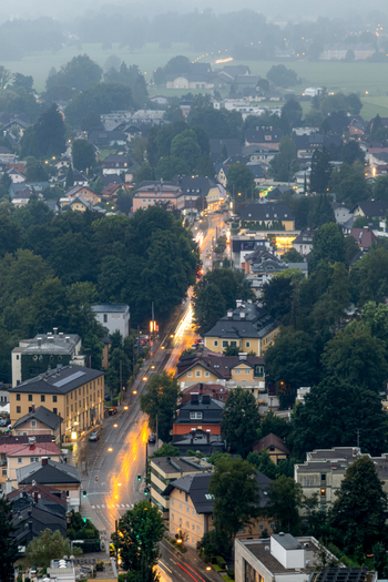 Aerial view of Salzburg at dusk with illuminated streets historic buildings and lush trees in Salzburg Salzburg Austria. Aerial view of Salzburg at dusk with illuminated streets historic buildings and lush trees in Salzburg Salzburg Austria.