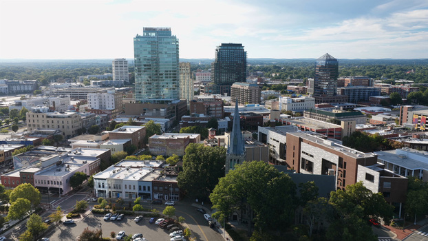Aerial view of the Durham skyline featuring modern high rise buildings historic church spires and urban streets in Durham North Carolina United States.