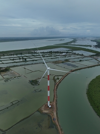 Aerial view of the Khurushkul wind turbine standing amidst coastal wetlands and river channels in Cox s Bazar Chittagong Division Bangladesh. Aerial view of the Khurushkul wind turbine standing amidst coastal wetlands and river channels in Cox s Bazar Chittagong Division Bangladesh.