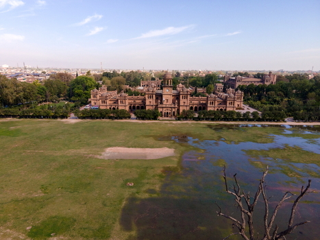 Aerial view of the historic Islamia College University Peshawar featuring iconic red brick architecture lush gardens and expansive grounds in Peshawar Khyber Pakhtunkhwa Pakistan. Aerial view of the historic Islamia College University Peshawar featuring iconic red brick architecture lush gardens and expansive grounds in Peshawar Khyber Pakhtunkhwa Pakistan.