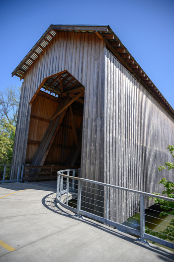 Aerial view of a wooden covered bridge with a concrete walkway and metal railings in Washington USA. Aerial view of a wooden covered bridge with a concrete walkway and metal railings in Washington USA.