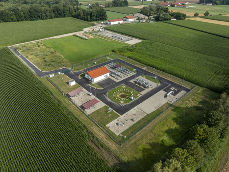 Aerial view of a natural gas facility surrounded by agricultural fields and corn crops in Finsing Bavaria Germany.
