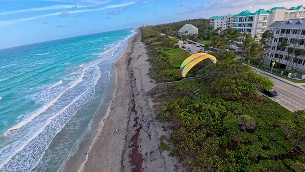 Aerial view of paraglider in Juno Beach United States. Aerial view of paraglider in Juno Beach United States.