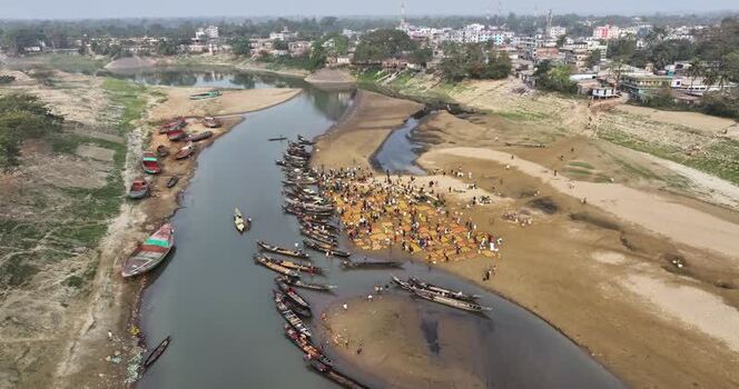 Aerial view of wooden boats and people by the river Bangladesh.