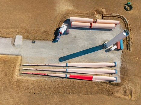 Aerial view of wind turbine blades and tower sections at a construction site on dry land Swellendam Western Cape South Africa. Aerial view of wind turbine blades and tower sections at a construction site on dry land Swellendam Western Cape South Africa.