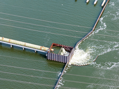 Aerial view of the water intake structure at the Maxima power plant with a pipeline and turbulent water flow in Lelystad Flevoland Netherlands. Aerial view of the water intake structure at the Maxima power plant with a pipeline and turbulent water flow in Lelystad Flevoland Netherlands.
