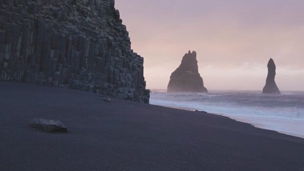 View of basalt columns and sea stacks on black sand beach Iceland. View of basalt columns and sea stacks on black sand beach Iceland.