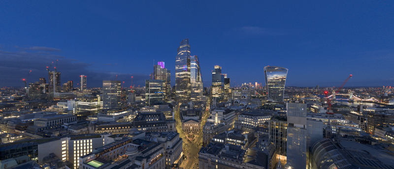 Aerial view of London s financial district skyline with illuminated skyscrapers and the Royal Exchange at twilight London London United Kingdom. Aerial view of London s financial district skyline with illuminated skyscrapers and the Royal Exchange at twilight London London United Kingdom.
