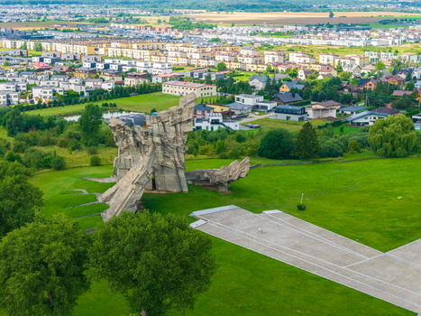 Aerial view of the IX fortas monument surrounded by green lawns and residential buildings in Kaunas Kaunas County Lithuania.