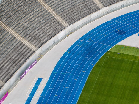 Berlin Germany 26 September 2026 Aerial view of Olympiastadion Berlin showing the blue running track green grass field and surrounding stadium seating.