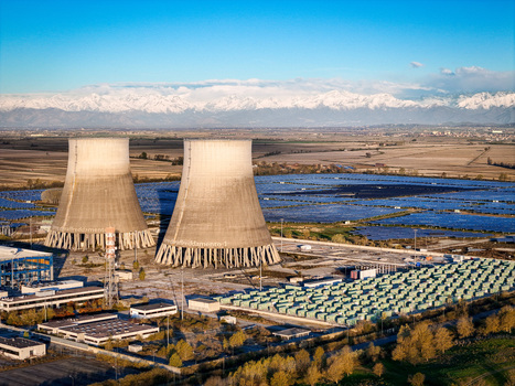 Trino Italy 30 March 2026 Aerial view of the imposing cooling towers casting long shadows over the solar farm juxtaposed against the distant snow capped Alps. Trino Italy 30 March 2026 Aerial view of the imposing cooling towers casting long shadows over the solar farm juxtaposed against the distant snow capped Alps.
