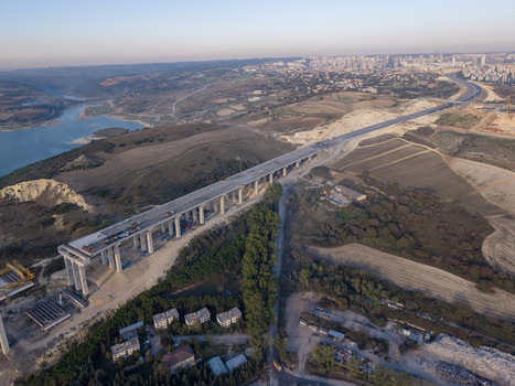 Aerial view of a bridge construction site with concrete pillars and elevated highway near a reservoir and rolling hills in Istanbul Istanbul Turkiye.