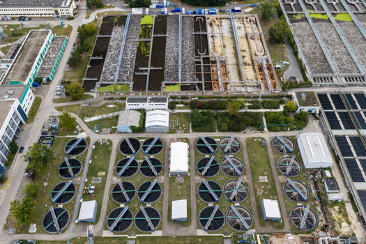 Aerial view of Klaerwerk Ruhleben a large wastewater treatment plant showing circular sedimentation tanks aeration basins and industrial infrastructure in Berlin Berlin Germany.