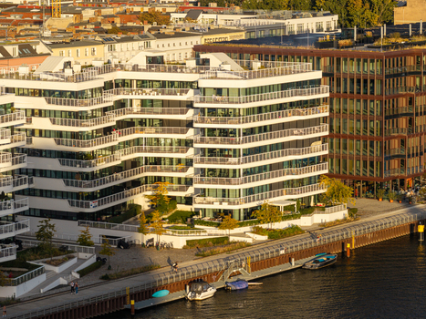 Aerial view of Spreespeicher Promenade featuring modern residential architecture with balconies along the Spree river in Berlin Berlin Germany. Aerial view of Spreespeicher Promenade featuring modern residential architecture with balconies along the Spree river in Berlin Berlin Germany.
