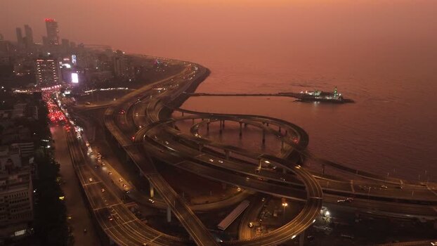 Aerial view of the Coastal Road interchange at dusk in Mumbai India. Aerial view of the Coastal Road interchange at dusk in Mumbai India.